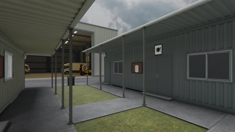 Covered walkways between workplace buildings, with trucks and a forklift in the background.