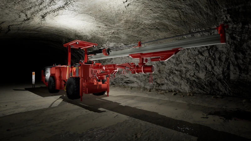 A red jumbo drill rig inside an underground mine tunnel.