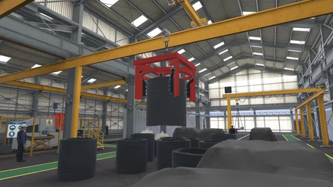 An overhead crane lifting a steel coil in a factory, with workers and safety barriers.